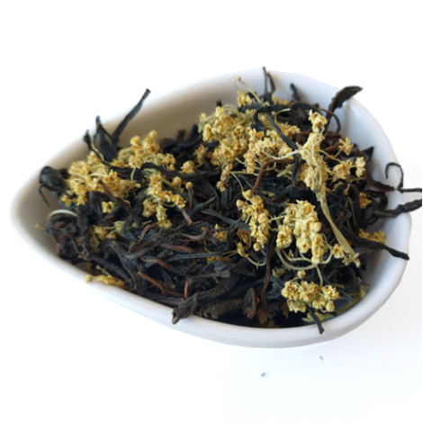 Linden & Black Tea Blend – black tea leaves with linden flowers in a dish